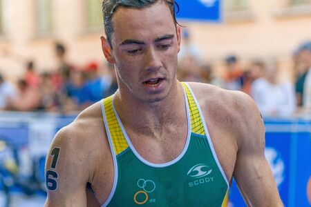STOCKHOLM, SWEDEN - AUG 22, 2015: Aaron Royle from Australia at the transition changing to cycling in the Men's ITU World Triathlon series eventのeditorial素材
