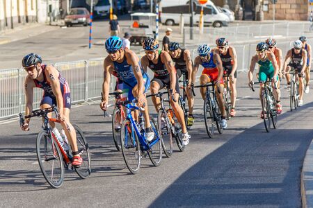 STOCKHOLM, SWEDEN - AUG 22, 2015: Group of male triathletes on bicycles at the Men's ITU World Triathlon series eventのeditorial素材