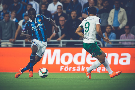 STOCKHOLM, SWEDEN - AUG 24, 2015: Sam Johnson driving the ball at the soccer game between the rivals Djurgarden and Hammarby at Tele2 arena.のeditorial素材