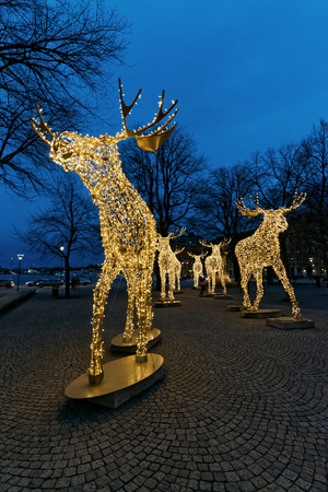 STOCKHOLM, SWEDEN - DEC 27, 2015: Group of Christmas moose made of led light at Nybrokajenのeditorial素材