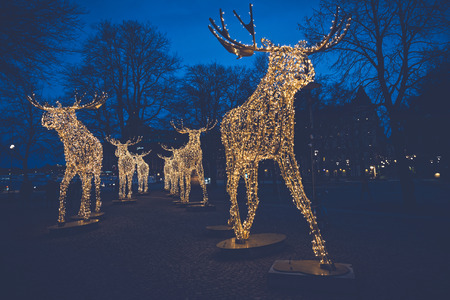 STOCKHOLM, SWEDEN - DEC 27, 2015: Group of Christmas moose made of led light at Nybrokajen, filters appliedのeditorial素材