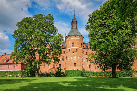 MARIEFRED, SWEDEN - JULY 28, 2015: Gripsholm castle in the idyllic small town of Mariefred. The tower in center in a lush garden.のeditorial素材