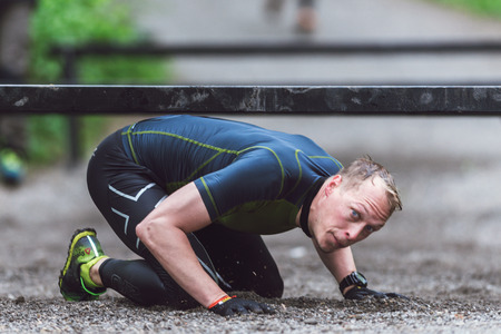 STOCKHOLM, SWEDEN - MAY 14, 2016 Tough Viking obstacle course around Stockholm Stadion and crawling under bars at this station.のeditorial素材