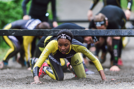 STOCKHOLM, SWEDEN - MAY 14, 2016 Tough Viking obstacle course around Stockholm Stadion and crawling under bars at this station.のeditorial素材