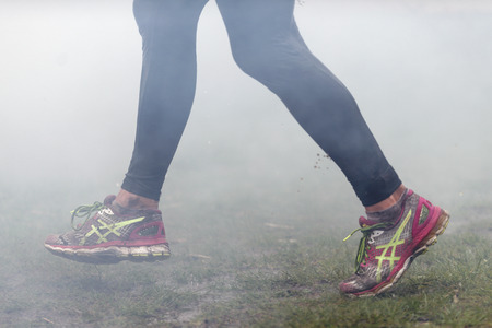 STOCKHOLM, SWEDEN - MAY 14, 2016 Tough Viking around Stockholm Stadion with the water and fire obstacle and closeup of muddy running shoes.のeditorial素材
