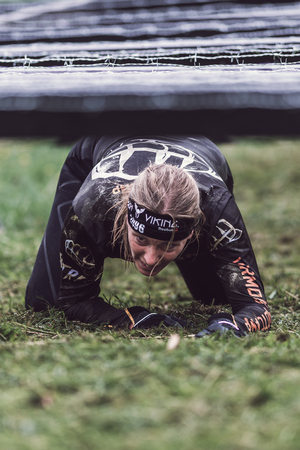 STOCKHOLM, SWEDEN - MAY 14, 2016 Tough Viking obstacle course around Stockholm Stadion with the barbed wire obstacle.のeditorial素材