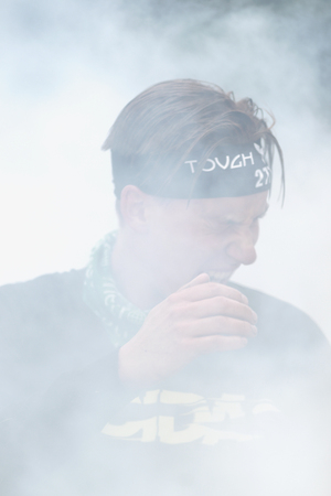 STOCKHOLM, SWEDEN - MAY 14, 2016 Tough Viking around Stockholm Stadion with the water and fire obstacle. Grin faces from the smokeのeditorial素材