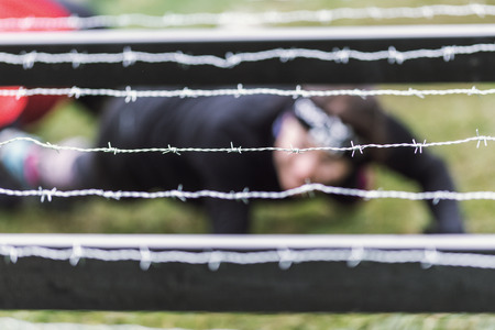 STOCKHOLM, SWEDEN - MAY 14, 2016 Tough Viking obstacle course around Stockholm Stadion with the barbed wire obstacle.のeditorial素材