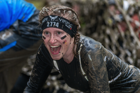 STOCKHOLM, SWEDEN - MAY 14, 2016 Female at the muddy net trap in Tough Viking obstacle course around Stockholm Stadion.のeditorial素材