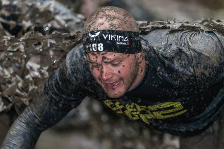 STOCKHOLM, SWEDEN - MAY 14, 2016 Muddy net trap in Tough Viking obstacle course around Stockholm Stadion.のeditorial素材