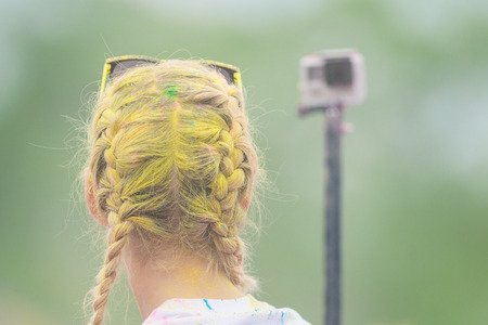 STOCKHOLM, SWEDEN - MAY 22, 2016: Girl taking selfie with a GoPro at Color Run Tropicolor world tour in Stockholmのeditorial素材