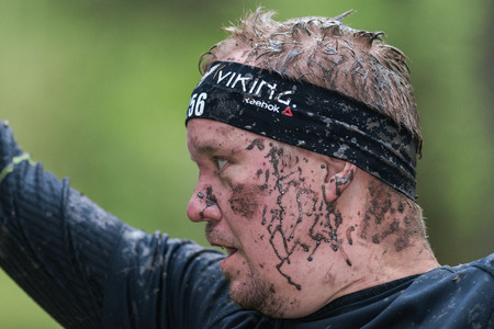 STOCKHOLM, SWEDEN - MAY 14, 2016 Face at slack line at Tough Viking obstacle course around Stockholm...
