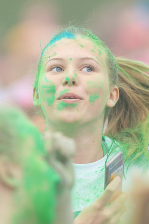STOCKHOLM, SWEDEN - MAY 22, 2016: Face of a young girl in pastel colors at Color Run Tropicolor...