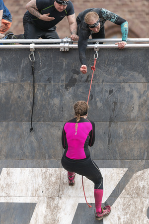 STOCKHOLM, SWEDEN - MAY 14, 2016 Woman climbing at Tough Viking obstacle course around Stockholm Stadion.のeditorial素材