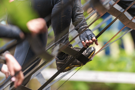 STOCKHOLM, SWEDEN - MAY 14, 2016 Closeup of feet climbing the A- frame at Tough Viking obstacle course around Stockholm Stadion.のeditorial素材