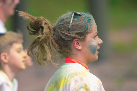 STOCKHOLM, SWEDEN - MAY 22, 2016: Sideview of girl running between the color stations at Color Run...