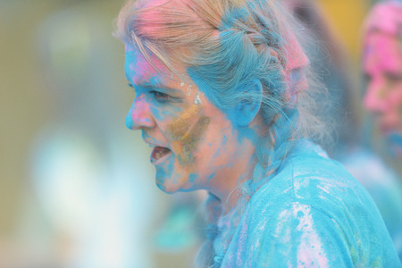 STOCKHOLM, SWEDEN - MAY 22, 2016: Sideview of female runner at the last blue station at Color Run Tropicolor world tour in Stockholmのeditorial素材