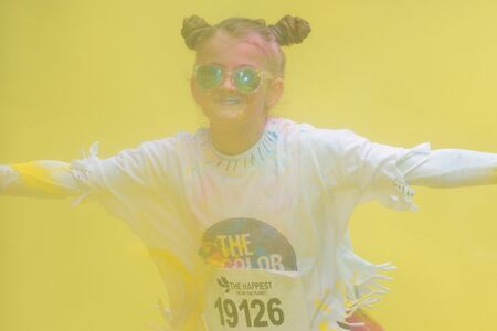 STOCKHOLM, SWEDEN - MAY 22, 2016: Young girl at the yellow station at Color Run Tropicolor world...