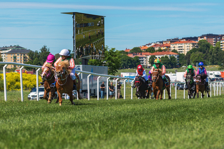 STOCKHOLM, SWEDEN - JUNE 6, 2016: Ponnies and young jockeys just after the start at Nationaldags Galoppen at Gardet.のeditorial素材
