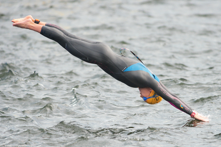 STOCKHOLM, SWEDEN - JULY 02, 2016: Warmup dive before the start at Women ITU Triathlon event in Stockholm.のeditorial素材