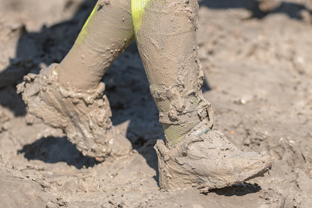 STOCKHOLM, SWEDEN - AUG 27, 2016: Mud Charge by Backstrom at the Tough Viking event at Gardet in Stockholm. Very muddy running shoesのeditorial素材