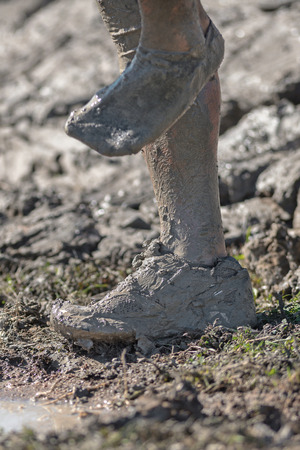 STOCKHOLM, SWEDEN - AUG 27, 2016: Shoes stuck at the Mud Charge by Backstrom at the Tough Viking event at Gardet in Stockholm. Muddy sockのeditorial素材