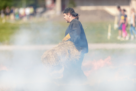 STOCKHOLM, SWEDEN - AUG 27, 2016: Official keeps the fire going at the Tough Viking event at Gardet in Stockholm.のeditorial素材