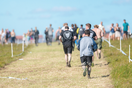 STOCKHOLM, SWEDEN - AUG 27, 2016: Running between the obstacles at the Tough Viking event at Gardet in Stockholm. Runners in the warm weather.のeditorial素材