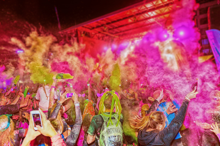 STOCKHOLM, SWEDEN - SEPT 18, 2016: Crowd throws color powder at the Color Run Night Edition in Stockholm. Throw of color powder and very detailedのeditorial素材
