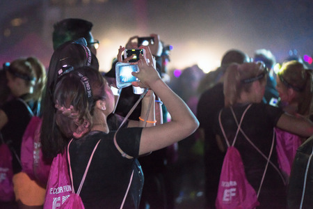 STOCKHOLM, SWEDEN - SEPT 18, 2016: Colorful happy people at the Color Run Night Edition in...