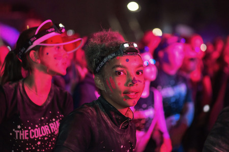 STOCKHOLM, SWEDEN - SEPT 18, 2016: Colorful happy female at the Color Run Night Edition in...