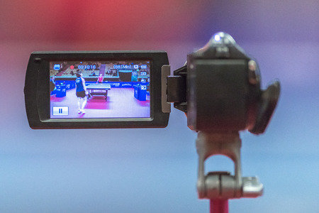 STOCKHOLM, SWEDEN - NOV 18, 2016: Camcorder at the table tennis tournament SOC at the arena Eriksdalshallen in Stockholm.のeditorial素材