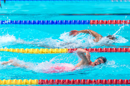 STOCKHOLM, SWEDEN - NOV 5, 2016: Swimmers crawling at the National Swedish swim competition at Eriksdalsbadet.のeditorial素材