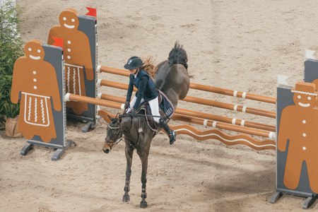 SOLNA, SWEDEN - NOV 26, 2016: Mathilda Bohlin at the Prince Carl Philip prize event in ponny jumping at the Sweden International Horse Show in Friends arena.のeditorial素材