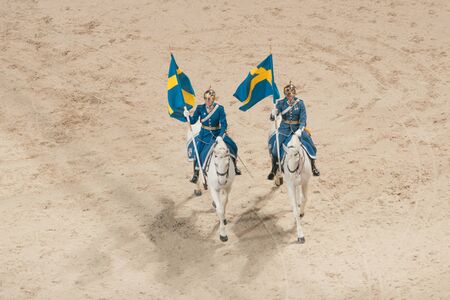 SOLNA, SWEDEN - NOV 26, 2016: Mounted royal guards with swedish flags at the prize cermony with...