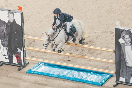SOLNA, SWEDEN - NOV 26, 2016: Olivia Ytterell at the Prince Carl Philip prize event in ponny jumping at the Sweden International Horse Show in Friends arena.のeditorial素材