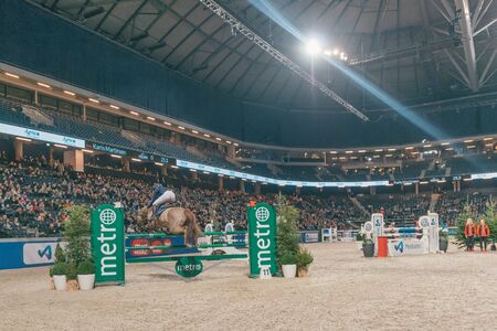 SOLNA, SWEDEN - NOV 27, 2016: Karin Martinsen at the Champion of the youngsters final in the Sweden International Horse Show at Friends arena.のeditorial素材