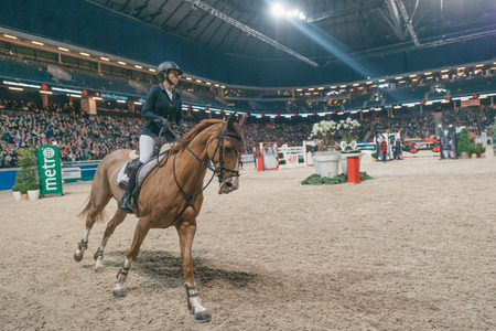 SOLNA, SWEDEN - NOV 27, 2016: Janika Sprunger at the Sweden Grand Prix in the Sweden International Horse Show at Friends arena.のeditorial素材