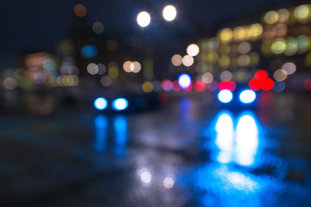 Defocused cars during night with colorful lights and reflections from the wet street. Swedenの写真素材