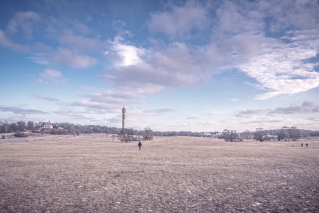 STOCKHOLM, SWEDEN, FEB 10, 2017: Recreational area Gardet during a cold winter day with people walking at the large grass field, Stockholmのeditorial素材