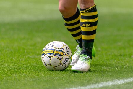SOLNA, SWEDEN - APRIL 17, 2017: Legs and feet of a AIK player at the derby match between AIK and Hammarby IF at the national stadium Friends Arena in Solna. Hammarby won with 2-1のeditorial素材