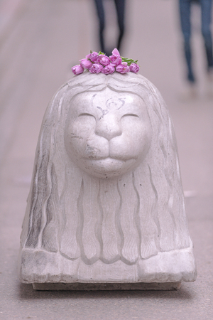 STOCKHOLM, SWEDEN - APRIL 16, 2017: Purple tulip flowers on the head of an concrete lion on Drottninggatan after the terror attack on the 7th of april.のeditorial素材