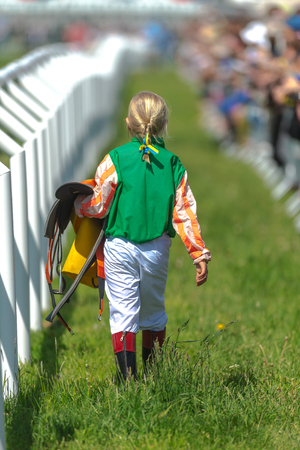 STOCKHOLM, SWEDEN - JUN 6, 2017: Young girl going to the weight in at the pony race competion at Nationaldagsgaloppen at Gardet.のeditorial素材