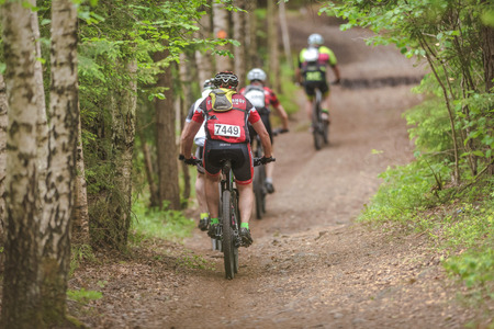 TULLINGE, SWEDEN - JUN 11, 2017: MTB riders at a forest trail at the event Lida Loop in the forests outside of Stockholm.のeditorial素材