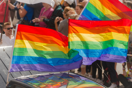 STOCKHOLM SWEDEN, 5 AUG, 2017: Closeup of Rainbow flags at the Pride parade in Stockholm with happy people and waving flags. Aprox 45 000 participants in the parade.のeditorial素材