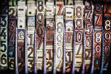 Numbers at a vintage stamper in closeup, colorful rubber numbers in different colors.の写真素材