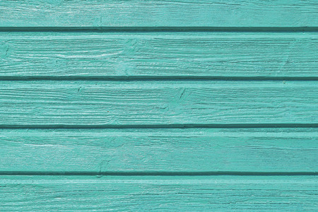 Newly turquise painted wooden panels on a house, shiny