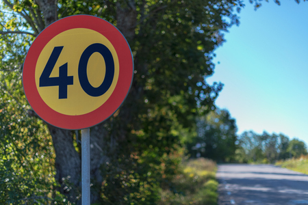 Traffic sign in limiting the speed to 40 kph at the road. Sweden