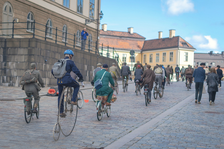 STOCKHOLM, SWEDEN, SEPT 22, 2018: Bike in tweed bicycle tour with vintage bikes and clothes. Before start with backdrop of city hall.のeditorial素材