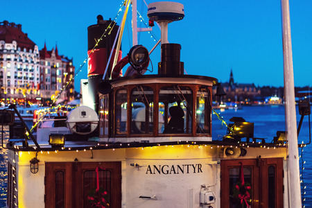 STOCKHOLM, SWEDEN - NOV 25, 2018: Angantyr steamboat from Stromma Kanalbolaget embarked with christmas lights at Nybrokajen during the night.のeditorial素材